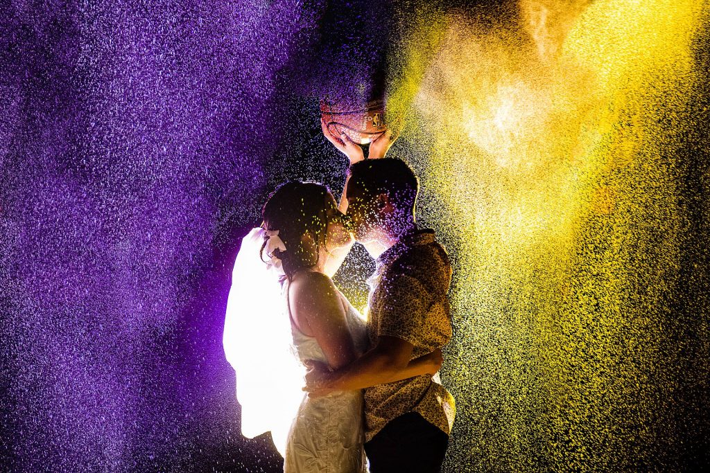 oceanfront maui wedding-angela-nelson-photography_0038 - Ann Arbor Wedding Photographer Angela Nelson Photography Couple kissing in purple and yellow powder
