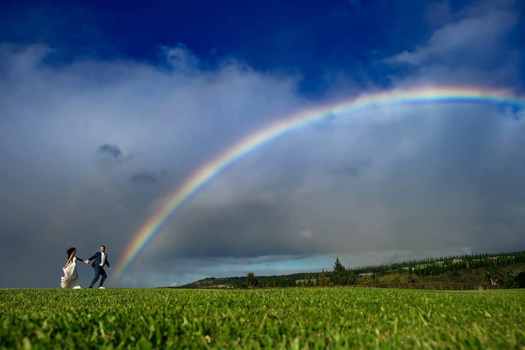 colorful-wedding-maui-pineapple-chapel_0018 - Ann Arbor Wedding Photographer Angela Nelson Photography Couple running under a Maui rainbow