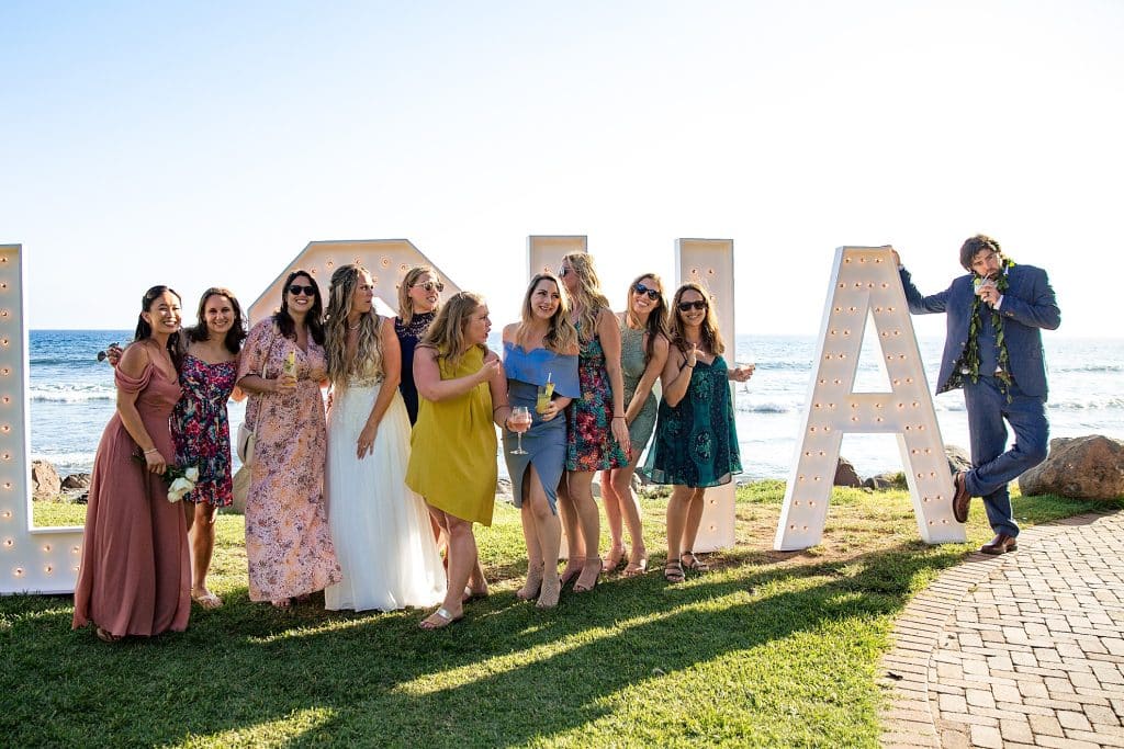 olowalu-plantation-house-cocktail-hour - Ann Arbor Wedding Photographer Angela Nelson Photography Wedding party posing by large illuminated letters
