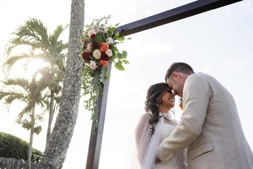 Juvy + Mark - Ann Arbor Wedding Photographer Angela Nelson Photography Couple embracing at Maui wedding altar